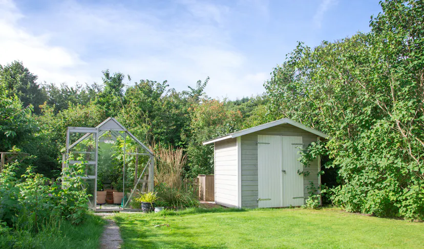 A small garden shed in a backyard in Essex UK in the background of Home.