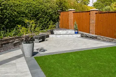 Scenic backyard in Essex UK with lawn and wooden fence.