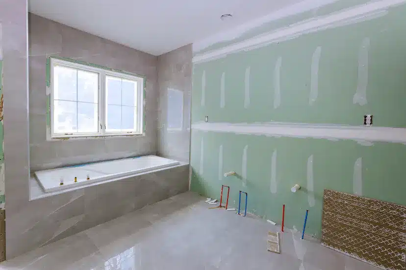 A Partial complete bathroom with Ceramic tiles installed and bath tub in Essex UK