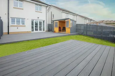 A deck with a wooden floor and a shed in Essex, UK.