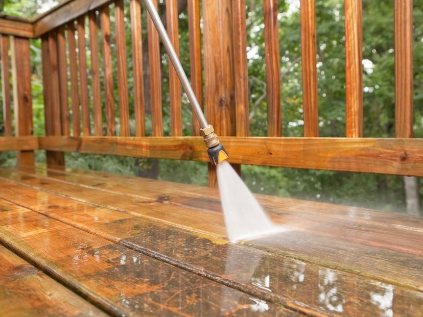 cleaning of wooden Deck Is shown with pressure washer somewhere in Essex County England UK