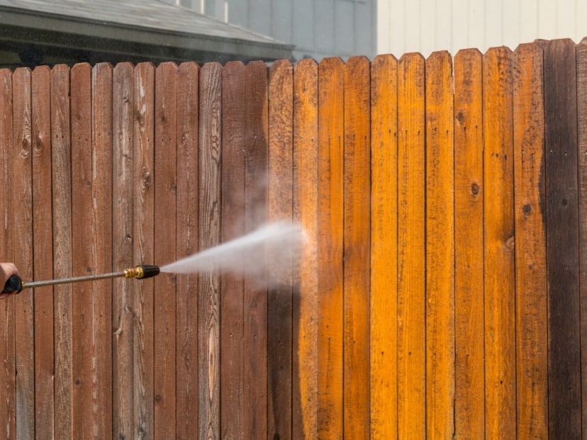 the image is showing pressure washing of wooden fence in Essex county England UK
