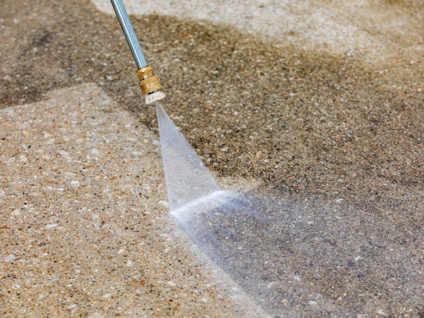 The picture is showing cleaning of floor with pressure washer In Essex UK